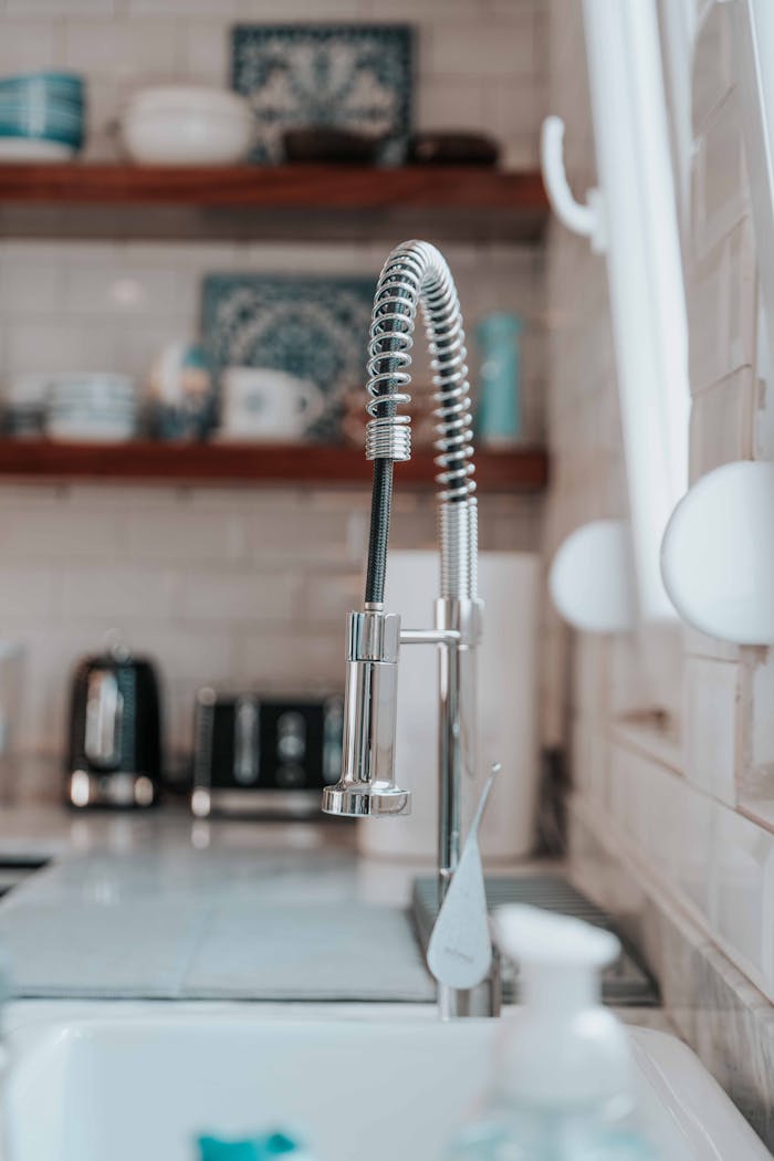 Close-up of a modern kitchen faucet with sleek, contemporary design in a home setting.